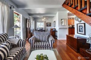 a living room with two couches and a table at Charming and cozy cottage at Maple Beach in Point Roberts +20 photos
