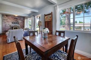 a dining room with a wooden table and chairs at Charming and cozy cottage at Maple Beach in Point Roberts