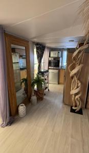 a living room with a kitchen and a room with wooden floors at My Freedom in Hyères