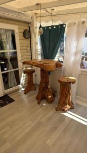 a wooden table and two stools on a porch at My Freedom in Hyères +12 photos