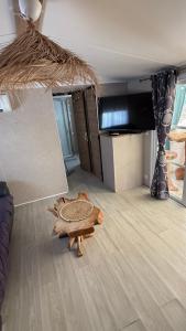 a living room with a table on the floor at My Freedom in Hyères