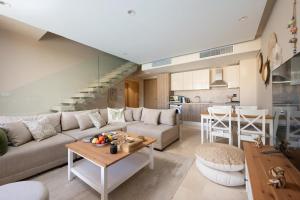 a living room with a couch and a table at VESTA - El Gouna Residence in Hurghada