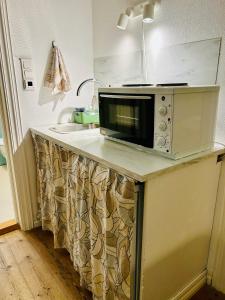 a microwave sitting on a counter in a kitchen at Sentralt og koselig in Kristiansand