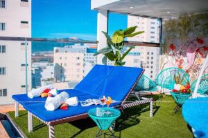 a blue table and chairs on a balcony with a view at Violet hotel 2 in Nha Trang