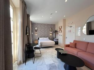 a living room with a couch and a bed at Smartr Malaga Centro in Málaga
