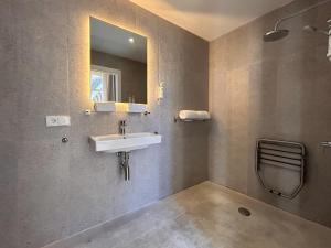 a bathroom with a sink and a mirror at Smartr Malaga Centro in Málaga +27 photos