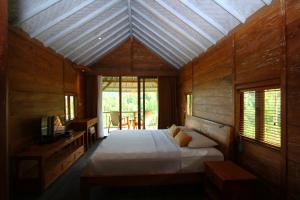 Postel nebo postele na pokoji v ubytování Melanting Cottages + 37 fotografií