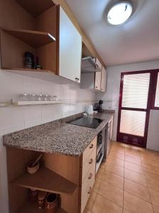 a kitchen with a sink and a counter top at Terraza Soleada in Puerto de Gandía
