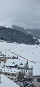 a snow covered field with people skiing on it at Hôtel du Centre in Villard-de-Lans