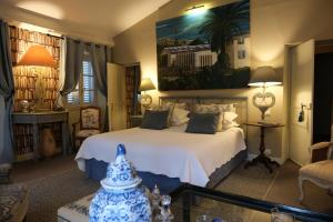 a bedroom with a bed with a blue and white bedspread at La Maison du Frene in Vence +42 photos