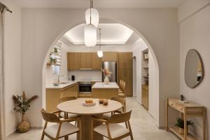 an open kitchen and dining room with a table and chairs at Alaia Boutique houses in Batsi