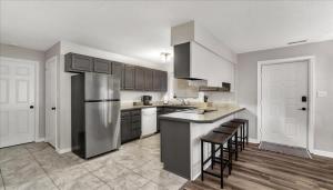a kitchen with a stainless steel refrigerator and cabinets at The Fox Hunt - A Ground Floor Condo in Southern Pines