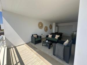 a living room with couches and a table at DuMar Beachouse in Salema