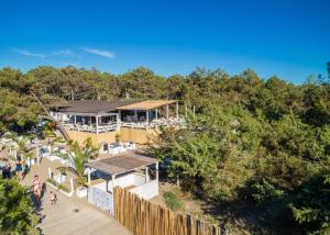 an overhead view of a house with a fence and trees at Bella Tents - Camping Vibes in Marina di Grosseto