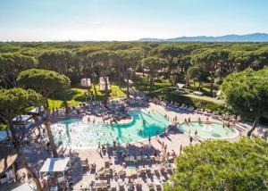 a group of people in a pool at a resort at Bella Tents - Camping Vibes in Marina di Grosseto