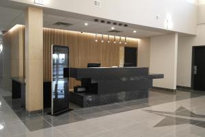 a lobby with a reception desk in a building at Stars Inn in Leduc