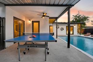 a ping pong table in the backyard of a house at Hollywood 4BR Home with Private Heated Pool in Hollywood