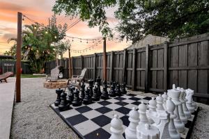 a chessboard is sitting on a chess board at Hollywood 4BR Home with Private Heated Pool in Hollywood