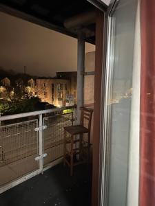 a chair sitting on a balcony with a window at Ganmos Place in Bracknell