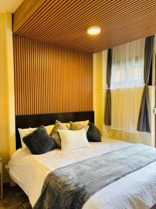 a bedroom with a large bed with white sheets and pillows at Utopía Hotel Boutique in Mexico City +112 photos