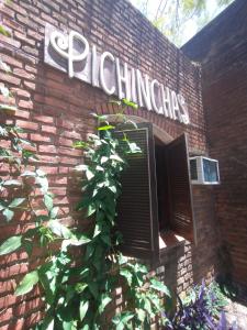 a brick building with a sign on the side of it at Alojamiento Pichinchas in Paso de los Libres
