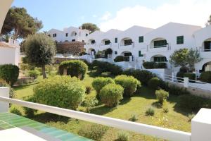 a view of the garden from the balcony of a villa at Apartamento Complejo Pinimar in Port d'Addaia