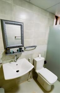 a bathroom with a white toilet and a sink at Moonlight Luxury Bubble Camp & Jeep Tours in Wadi Rum +64 photos