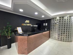 a wine bar in a restaurant with a wall of wine bottles at Max Hotel in Brasília