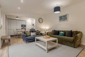 a living room with a couch and a table at Rusheen Cottage in St. Andrews