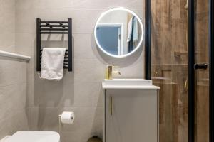 a bathroom with a sink and a mirror at Rusheen Cottage in St. Andrews +20 photos