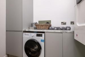 a laundry room with a washer and dryer at Rusheen Cottage in St. Andrews