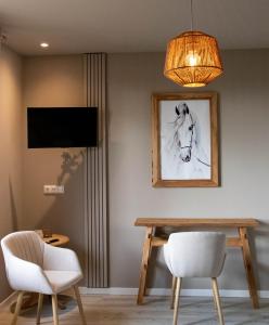 a dining room with a table and a chandelier at Eighty One Horse Boulevard in Valkenswaard