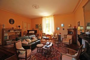 a living room with a couch and a fireplace at Le Masbareau, Chambre et Table d'Hôtes de Charme, B&B in Royères-Saint-Léonard