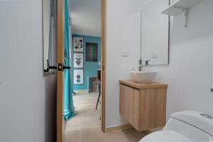 a bathroom with a sink and a mirror at Leb'Den Executive Suites in Cali +207 photos