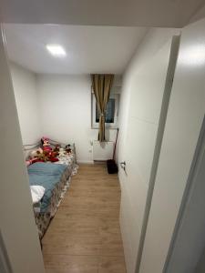 a small room with a bed and a hallway at Stan na dan Jelah in Jelah