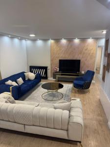 a living room with a couch and a table and a tv at Stan na dan Jelah in Jelah