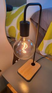 a glass lamp on top of a table at Le Clocher, nice warm and comfortable nest in Sierentz