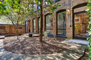 a tree in front of a brick building at Luxe 220 Suite 3 in Wilmington