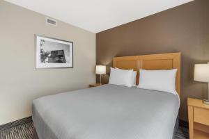 a bedroom with a large bed and two lamps at Best Western Grande Prairie in Grande Prairie +51 photos
