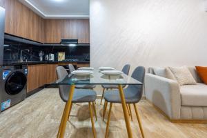 a dining room with a glass table and a couch at Magnificent apartment 10 in Casablanca
