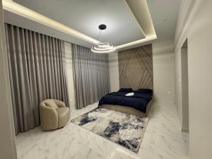 a bedroom with a bed and a chair at Faj Residence home stay in Ajman 