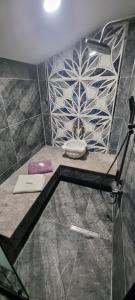 a bathroom with a shower with a flower pattern on the wall at Özer hızarcıoglu in Talipler +16 photos