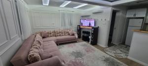 a living room with a couch and a television at Özer hızarcıoglu in Talipler