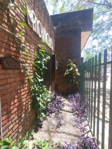 a brick building with a gate and a fence at Alojamiento Pichinchas in Paso de los Libres