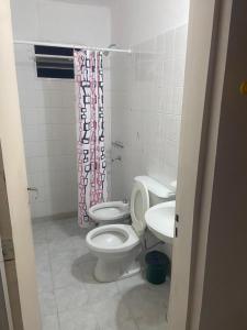 a bathroom with a toilet and a sink at Hotel Corona del inca in Vinchina