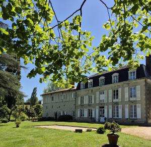 an old stone building with trees in the foreground at Le Masbareau, Chambre et Table d'Hôtes de Charme, B&B in Royères-Saint-Léonard