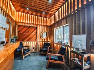 a room with wooden walls with chairs and a bar at Utopía Hotel Boutique in Mexico City