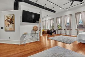 a living room with a flat screen tv on the wall at Luxe 220 Suite 4 in Wilmington