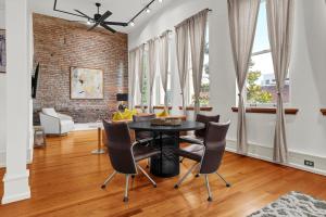 a dining room with a black table and chairs at Luxe 220 Suite 4 in Wilmington