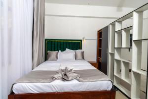 a bedroom with a bed with a bow on it at MIG Studios in Nakuru